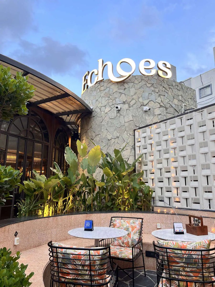 The Echoes entrance with tables set beneath the sign