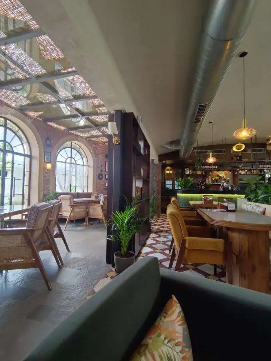 Dining room under a glass skylight with cane chairs